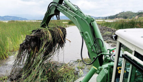 Watermaster_Dredger_removing_invasive_vegetation_from_a_lake_by_raking+copy